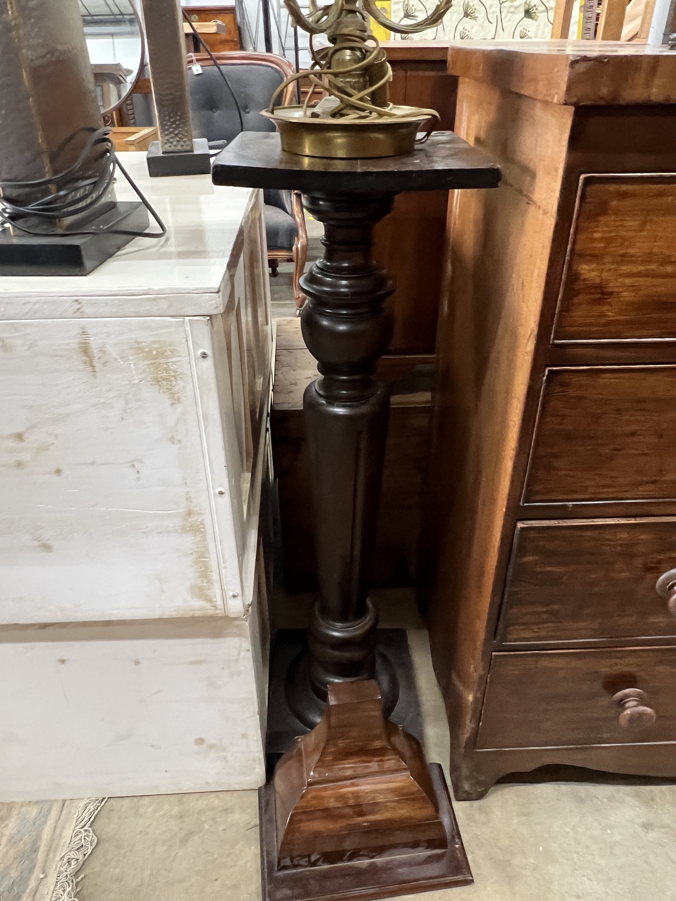 A gilt metal three branch table lamp with toleware shade, a mahogany pedestal and a wall bracket
